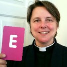 Rev Lucy Winkett holding the letter E