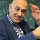 Jim Al-Khalili in front of a blackboard full of maths