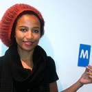 Minna Salami holding the letter M