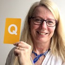 Ruth Scott holding the letter Q