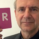 Fr Christopher Jamison holding the letter R