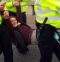 Rev Jo Rand being carried away by police