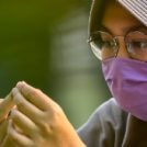 Woman in face mask and scarf