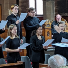 A choir rehearses carols